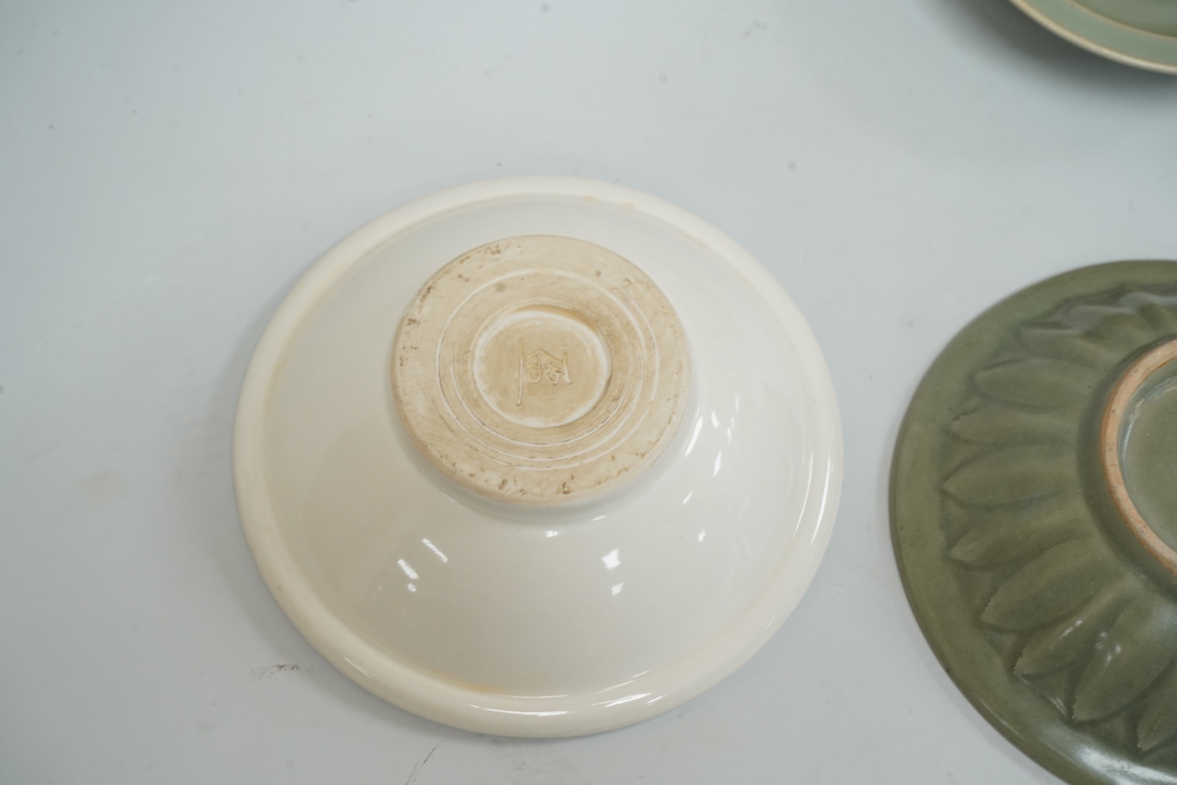 A Chinese celadon glazed twin fish dish, another similar and a white glazed bowl, largest 13.5cm